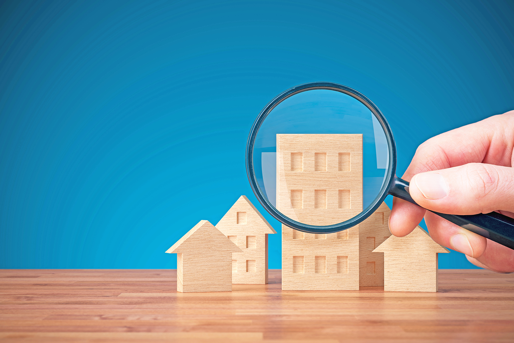 Focus on real estate and property insurance concept. Wooden models of different types of houses